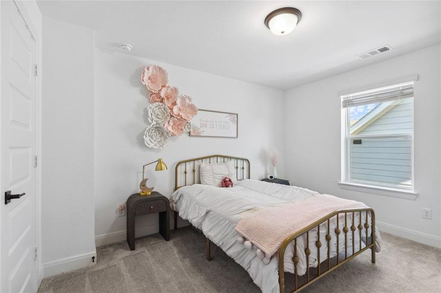 Bedroom featuring baseboards, visible vents, and carpet Bedroom featuring baseboards, visible vents, and carpet