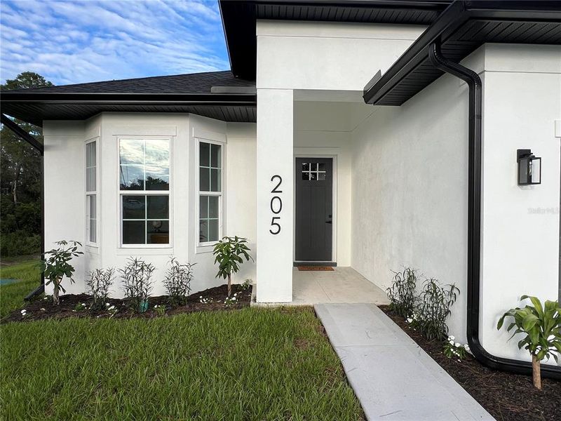 Front exterior of a new home in , Deltona, FL, highlighting curb appeal (Image 28). Front exterior of a new home in , Deltona, FL, highlighting curb appeal (Image 28).