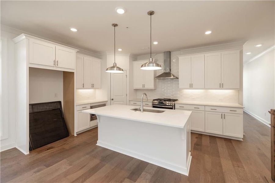 42" upper cabinets with crown molding, soft close doors, light rail and pendant lights are all standard features in this amazing kitchen.
