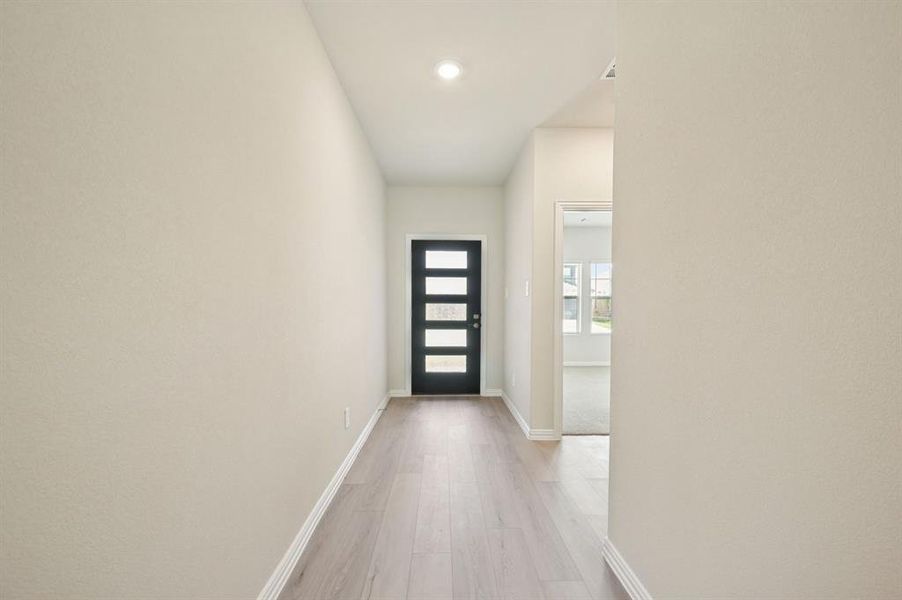 Front door entry featuring wood finished floors and recessed lighting