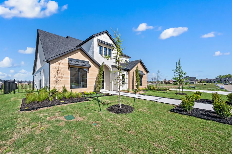 Front exterior of a new home in The Resort on Eagle Mt. Lake, Fort Worth, TX, highlighting curb appeal (Image 26).
