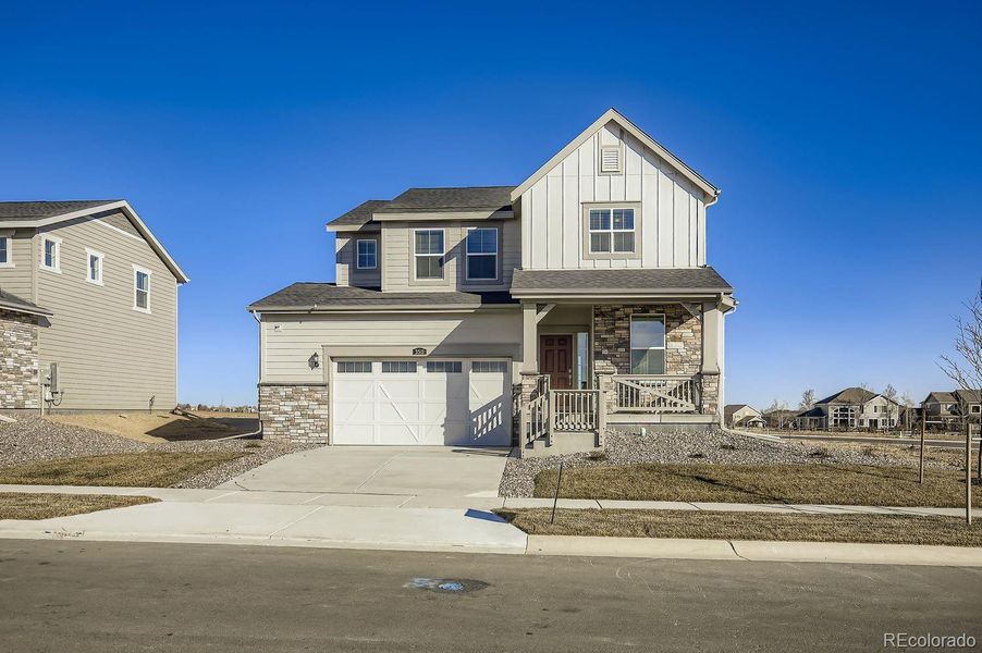 Front exterior of a new home in Riano Ridge, Loveland, CO, highlighting curb appeal (Image 1). Front exterior of a new home in Riano Ridge, Loveland, CO, highlighting curb appeal (Image 1).