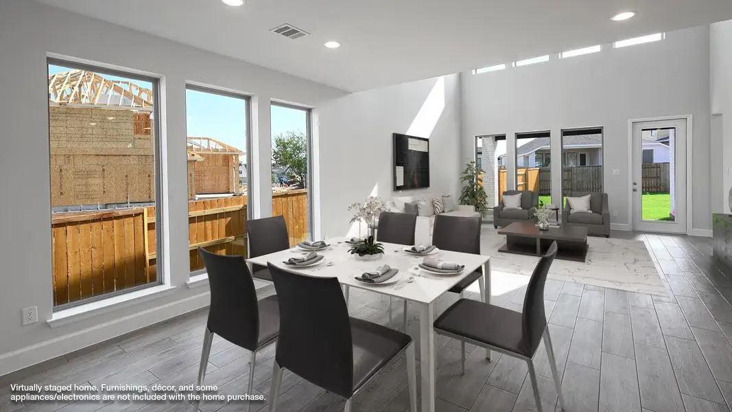 Dining room with wood finished floors, recessed lighting, and healthy amount of natural light