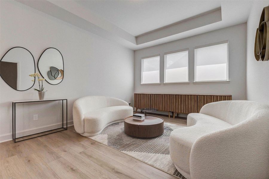 This modern living space features light wood flooring, two cozy white sofas, and a stylish wooden sideboard. The room is brightened by three large windows, and decorated with contemporary mirrors and a chic coffee table, creating an inviting and elegant atmosphere. This modern living space features light wood flooring, two cozy white sofas, and a stylish wooden sideboard. The room is brightened by three large windows, and decorated with contemporary mirrors and a chic coffee table, creating an inviting and elegant atmosphere.