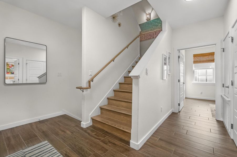 Staircase featuring wood finished floors Staircase featuring wood finished floors