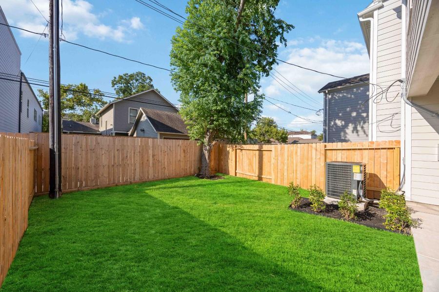 Fully fenced backyard with just the right amount of green space for pets, play, or a garden.