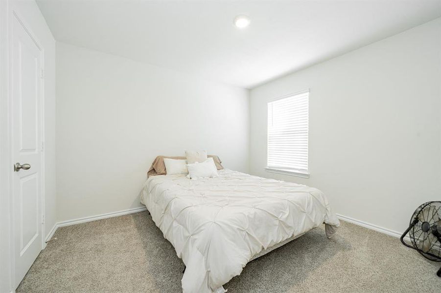 Carpeted bedroom with baseboards and recessed lighting Carpeted bedroom with baseboards and recessed lighting