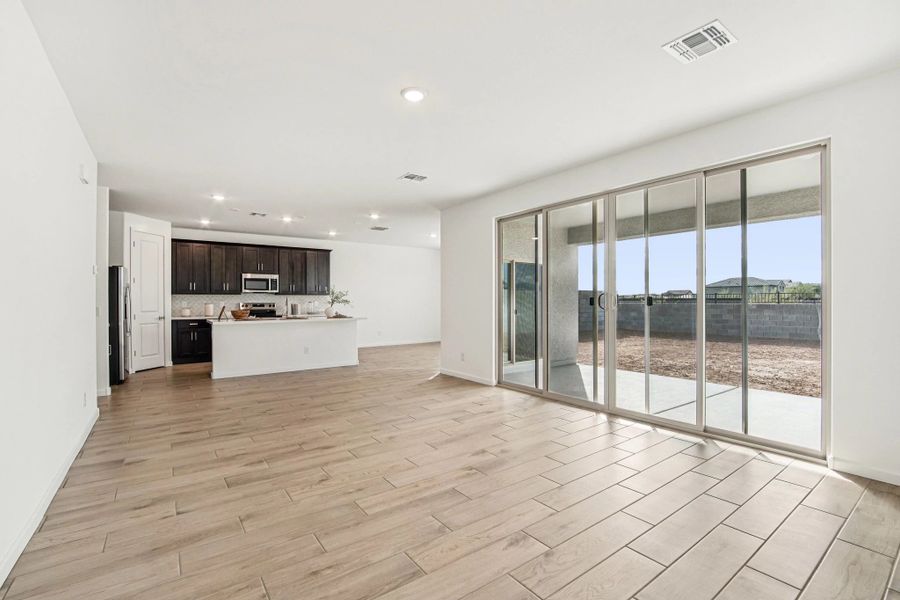 Great room, kitchen and dining. Options and finishes may vary.
