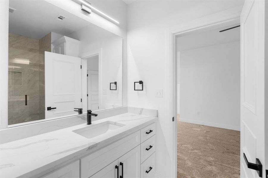 Full bath featuring vanity and a stall shower Full bath featuring vanity and a stall shower
