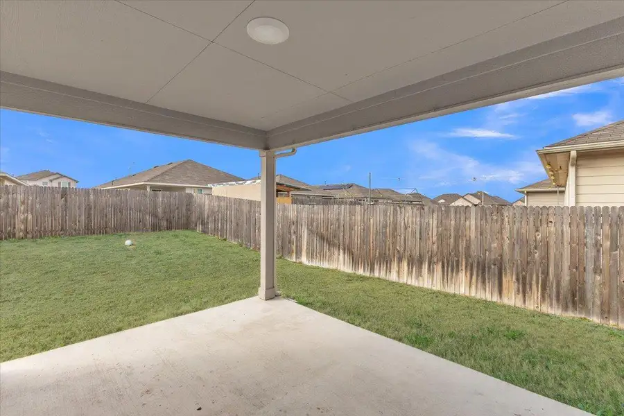 Fenced backyard with a patio area