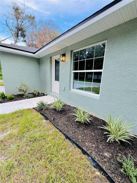 Front exterior of a new home in , Lakeland, FL, highlighting curb appeal (Image 2).