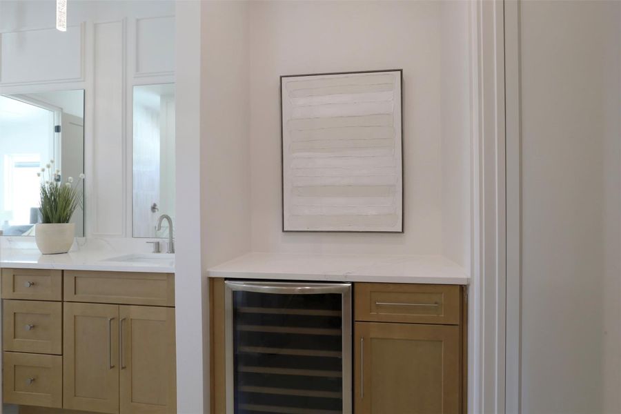 Private cabinet section equipped with a 24” wine fridge and prewired outlet ready for a future coffee station.
