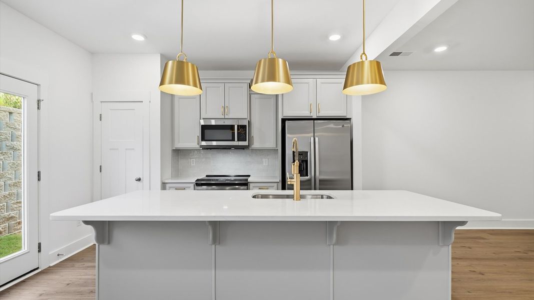 Tasteful kitchen with a streamlined island and modern finishes in a first-class DRB Homes design