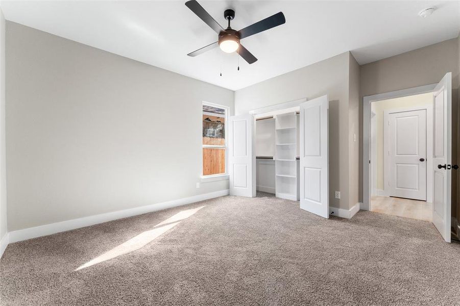 Unfurnished bedroom with light carpet, a closet, and ceiling fan