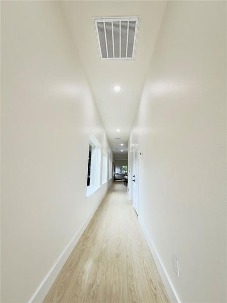 Hallway with recessed lighting and wood finished floors