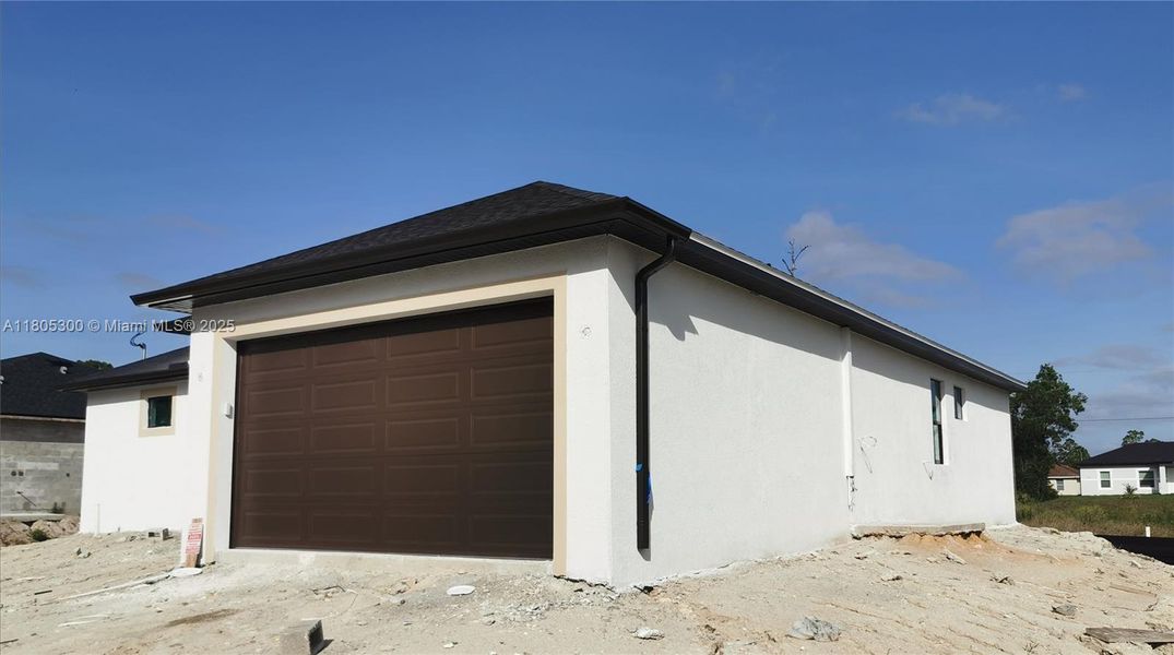 Front exterior of a new home in , Lehigh Acres, FL, highlighting curb appeal (Image 1).
