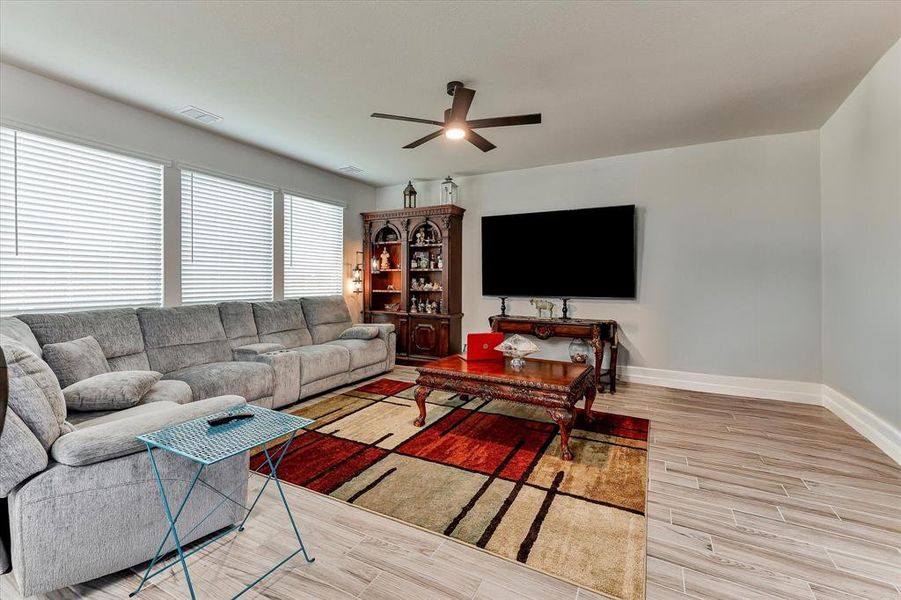 Spacious living room includes a wall of windows for tons of natural light, ceramic tile flooring and ceiling fan Spacious living room includes a wall of windows for tons of natural light, ceramic tile flooring and ceiling fan
