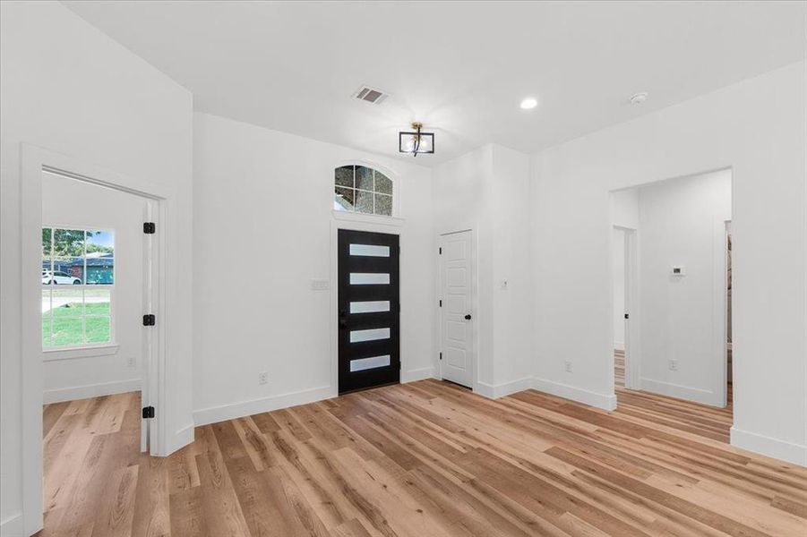 Entrance foyer with light hardwood / wood-style floors