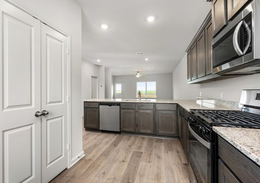 The kitchen looks out into the dining room and family room.