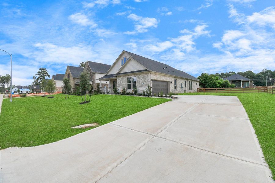Front exterior of a new home in Timber Hollow: Heritage Collection, Magnolia, TX, highlighting curb appeal (Image 24). Front exterior of a new home in Timber Hollow: Heritage Collection, Magnolia, TX, highlighting curb appeal (Image 24).