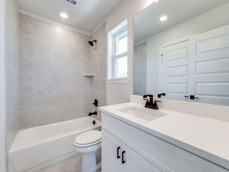 Friends and family will feel right at home in any of the guest baths in this dream home!