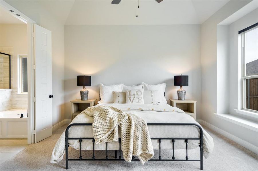 Bedroom featuring baseboards, light colored carpet, and ceiling fan Bedroom featuring baseboards, light colored carpet, and ceiling fan