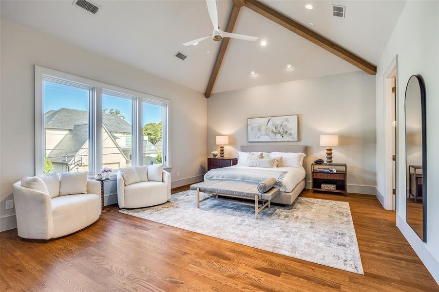 Bedroom featuring wood finished floors, beamed ceiling, a ceiling fan, recessed lighting, and high vaulted ceiling Bedroom featuring wood finished floors, beamed ceiling, a ceiling fan, recessed lighting, and high vaulted ceiling