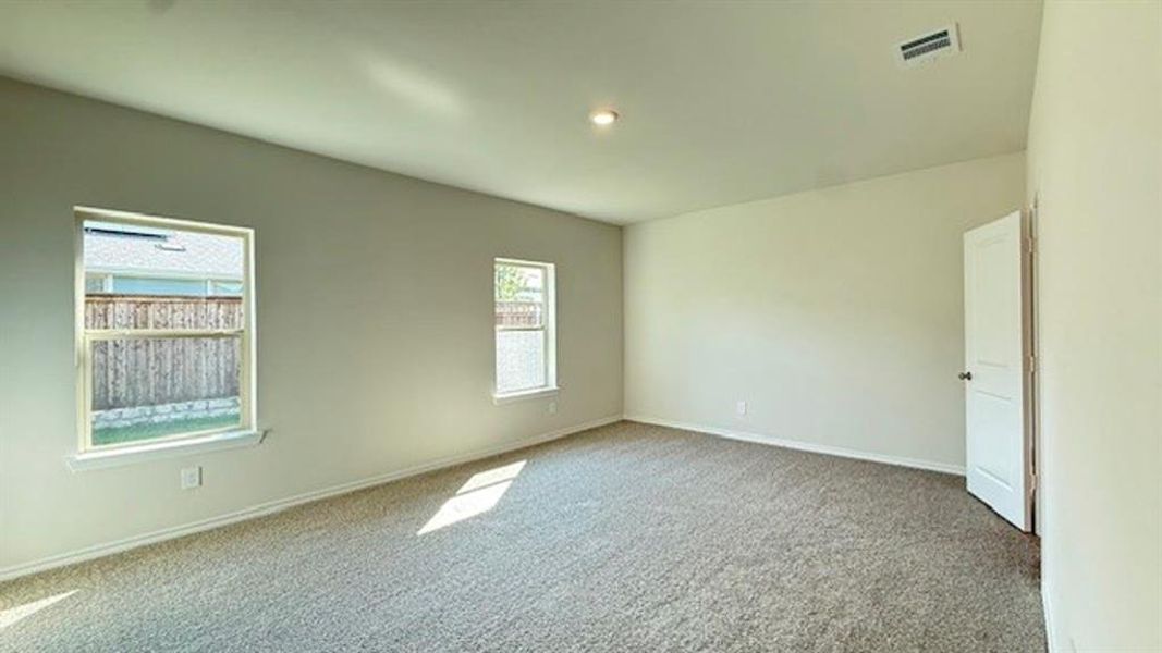 Spare room with light carpet and baseboards