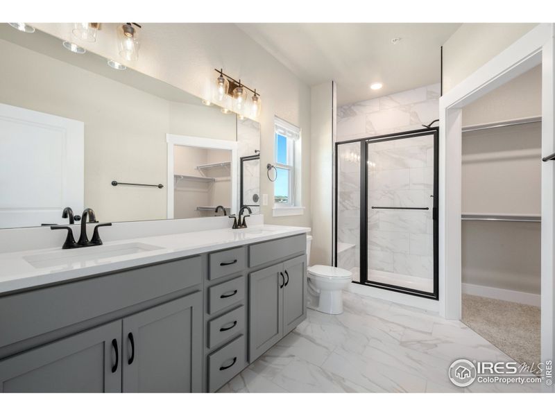 Primary bathroom w/ dual vanity.