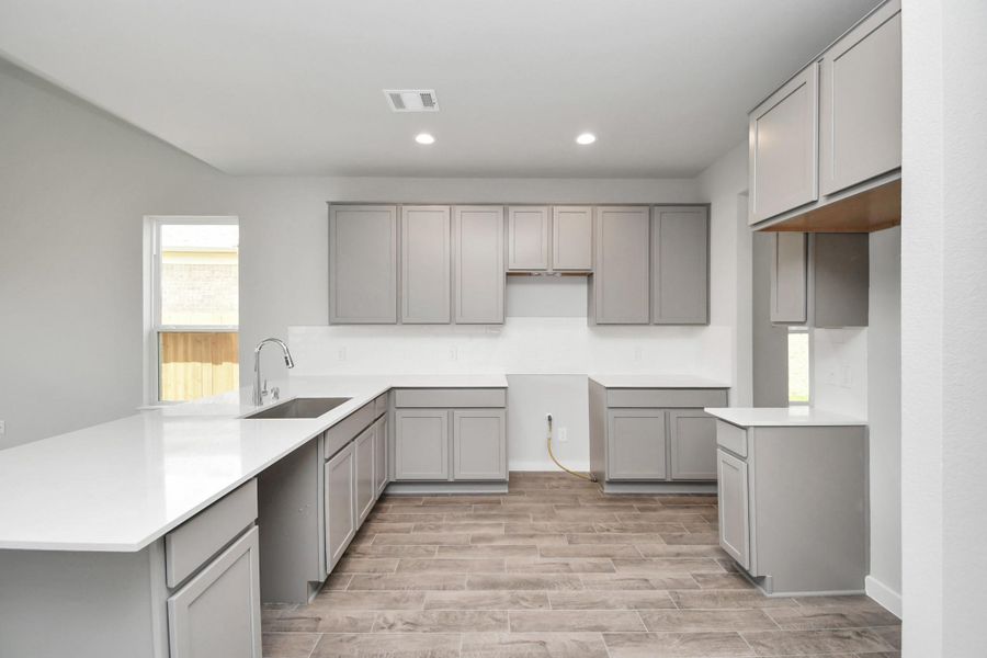This generously spacious kitchen is a dream realized! Sample photo of completed home with same plan. Actual colors and selections may vary. This generously spacious kitchen is a dream realized! Sample photo of completed home with same plan. Actual colors and selections may vary.