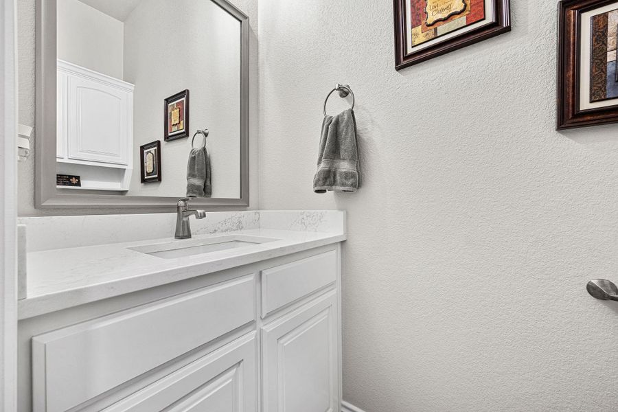 A well-appointed bathroom features a sleek vanity with ample storage beneath a substantial mirror. A well-appointed bathroom features a sleek vanity with ample storage beneath a substantial mirror.