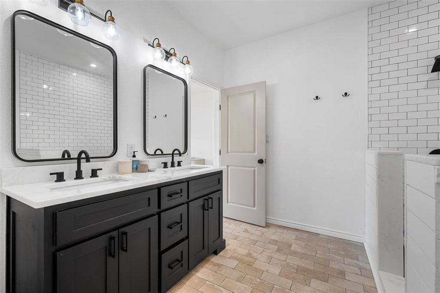 Full bathroom featuring double vanity and walk in shower