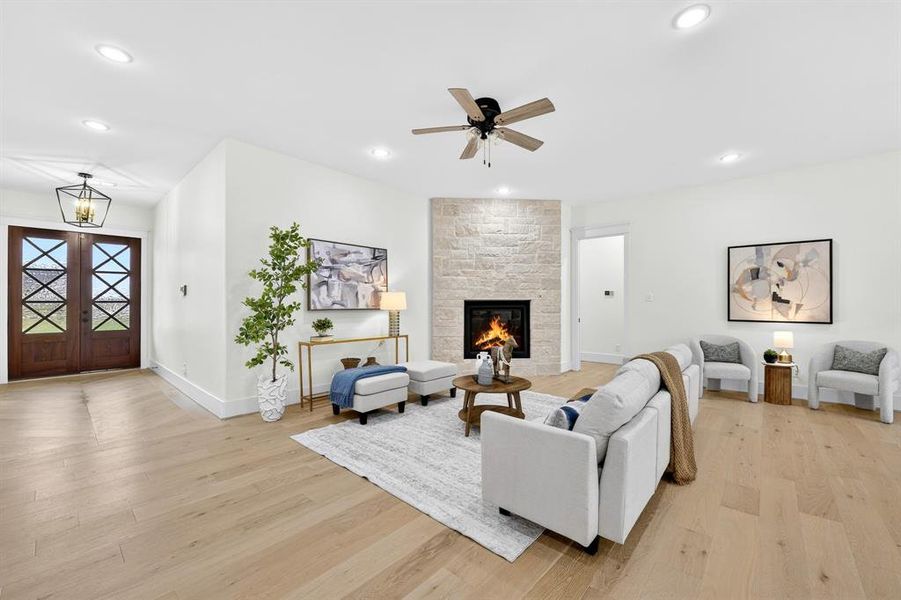Welcome in! Gorgeous wood and glass entry door with ample light color wood flooring greets you as you enter!