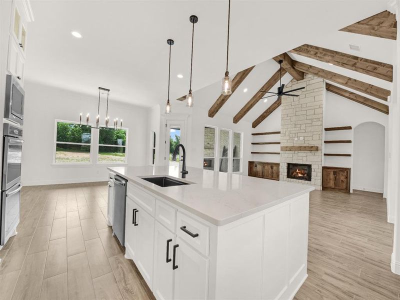 Kitchen with a sink, a ceiling fan, appliances with stainless steel finishes, recessed lighting, and light wood-style flooring