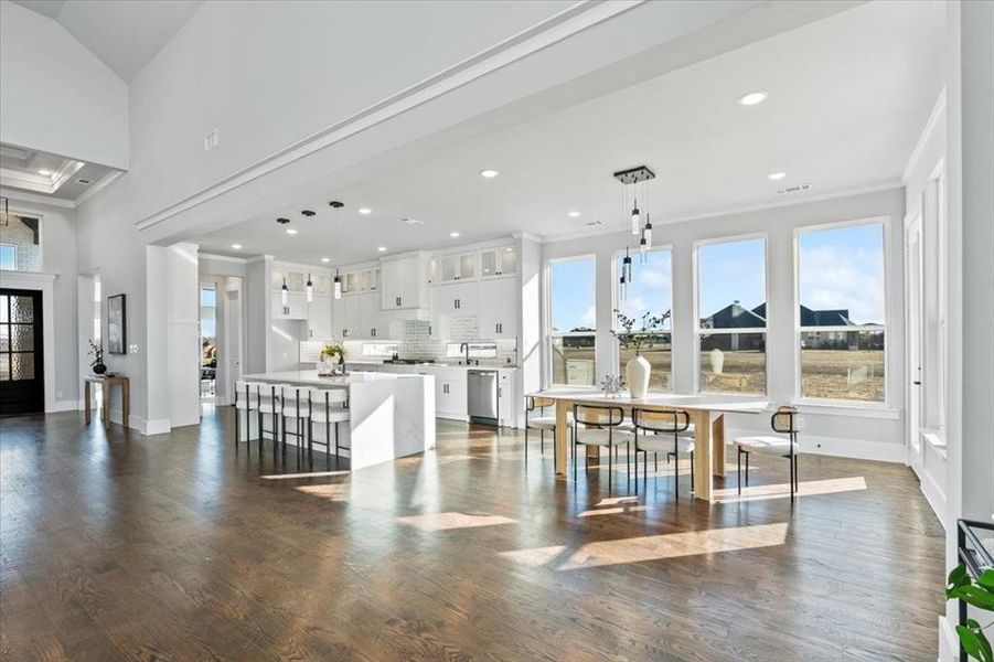 Dining space featuring ornamental molding and dark hardwood / wood-style floors