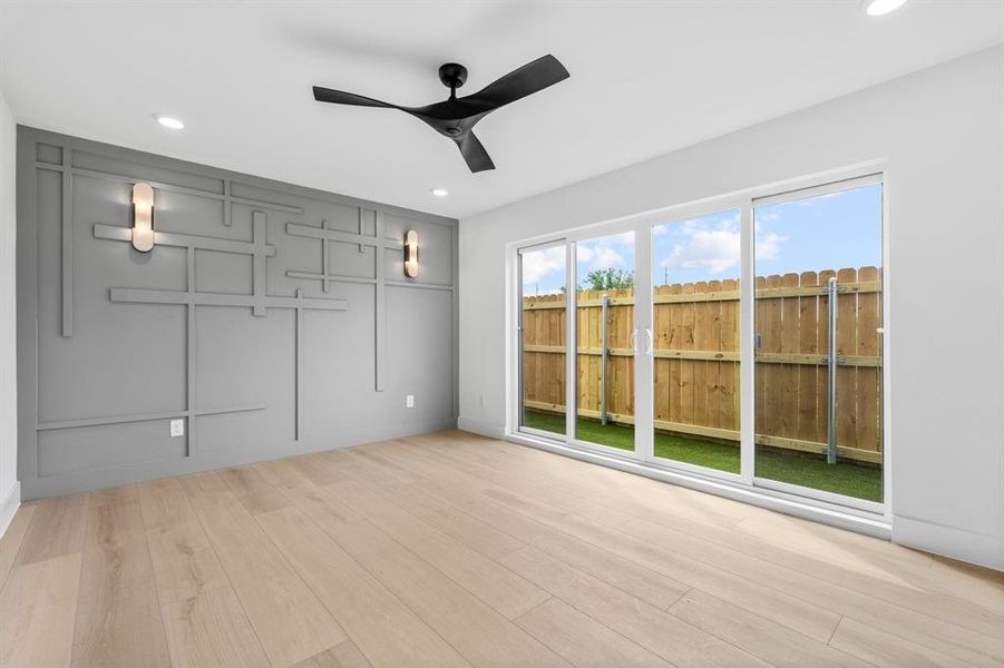Empty room with ceiling fan, light wood-style floors, and recessed lighting
