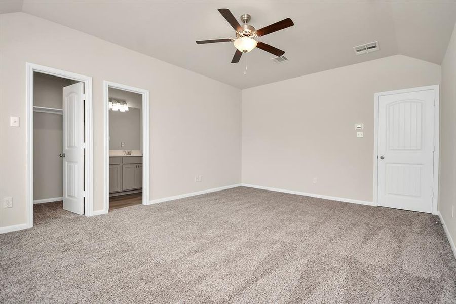 The primary bedroom features a walk-in closet for all your storage needs, and an en-suite bathroom for added privacy and convenience. **This image is from another Saratoga Home with similar floor plan and finishes, not the Brittany floorplan.**