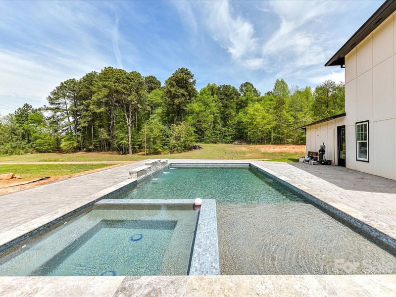 Spacious outdoor patio with an in-ground pool and spa, offering a great opportunity to customize your dream backyard retreat.