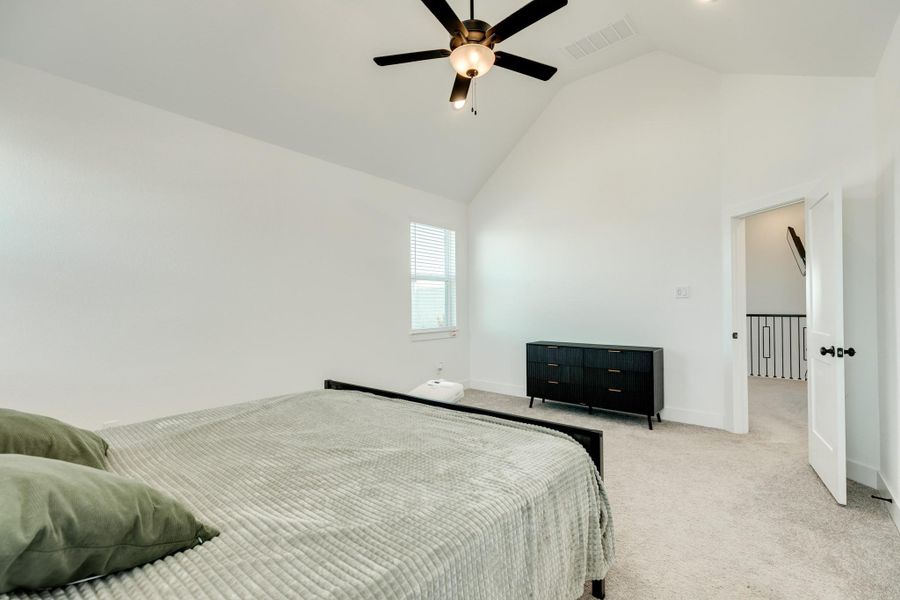 The primary bedroom is a spacious area with a backyard view.