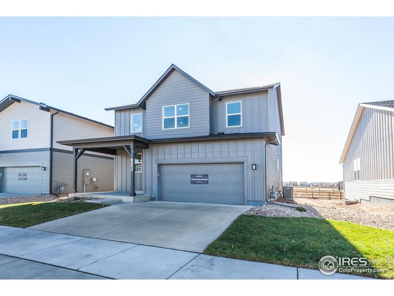 Front exterior of a new home in Trailside Story Collection - Single Family Homes, Timnath, CO, highlighting curb appeal (Image 2).