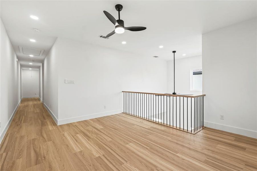 Spare room featuring a ceiling fan, attic access, light wood-style floors, and recessed lighting