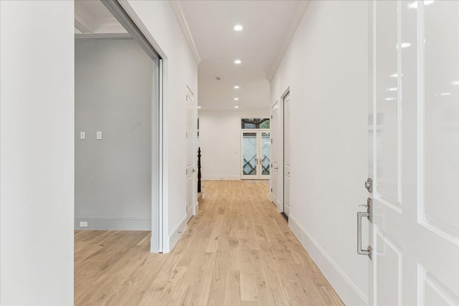 Step into this bright and welcoming formal entry. The first floor living space features 11-foot ceilings, Legno Bastone engineered White Oak wood floors, and designer light fixtures.