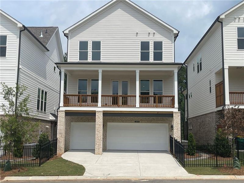 Front exterior of a new home in Waterside Single Family, Peachtree Corners, GA, highlighting curb appeal (Image 2). Front exterior of a new home in Waterside Single Family, Peachtree Corners, GA, highlighting curb appeal (Image 2).
