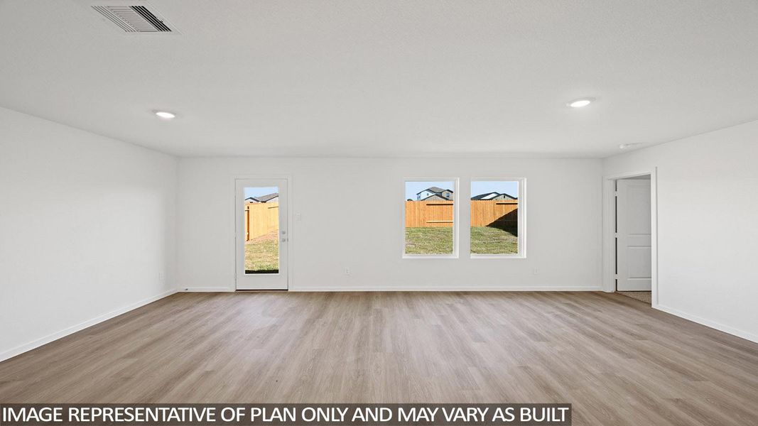 Empty room with light wood-style floors and recessed lighting