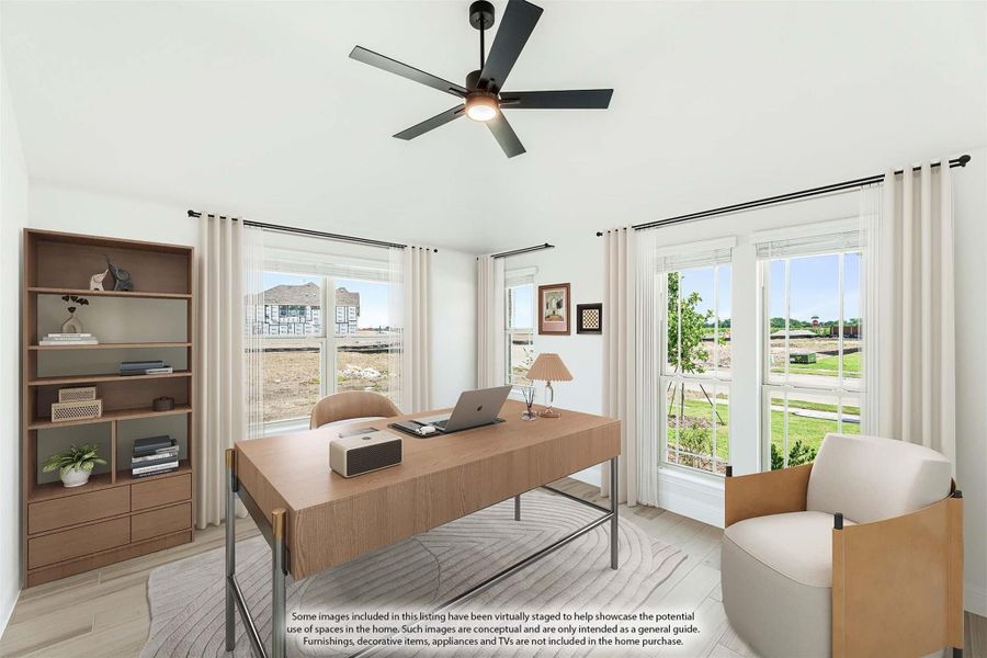 Home office with wood desk, ceiling fan, built-in bookshelf, and large windows with outdoor views