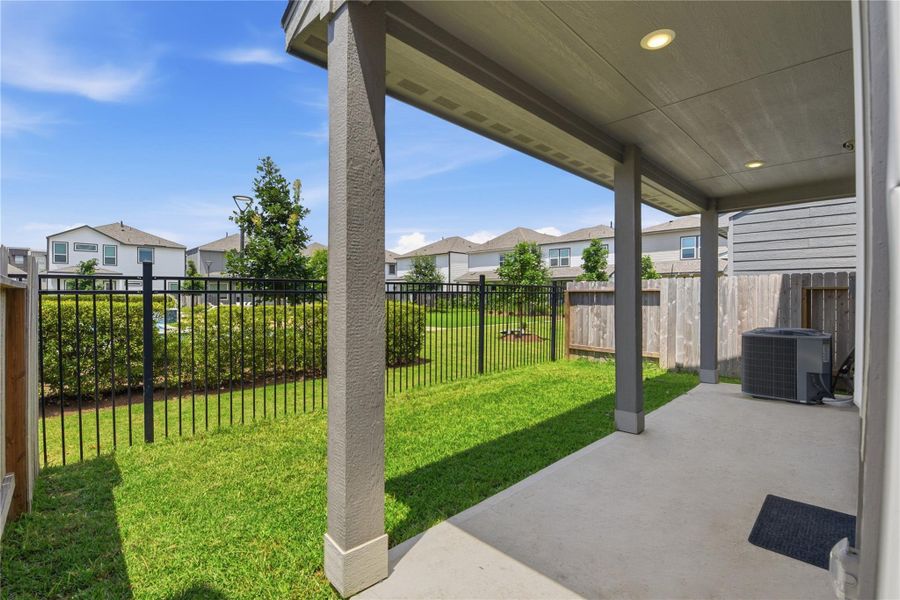 Exterior details and patio area of a home in Dunvale Village - Townhome Collection, Houston (Image 27).