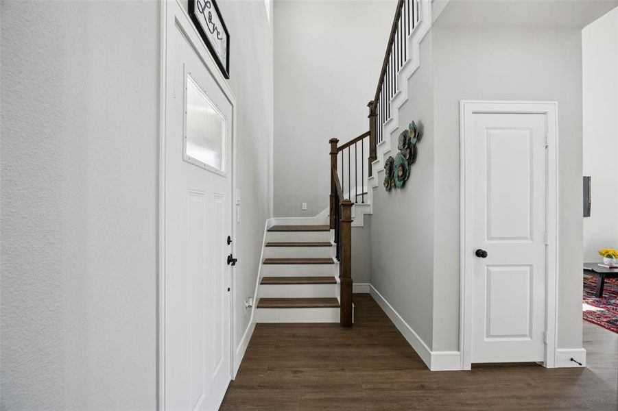 Stairway featuring wood finished floors and baseboards