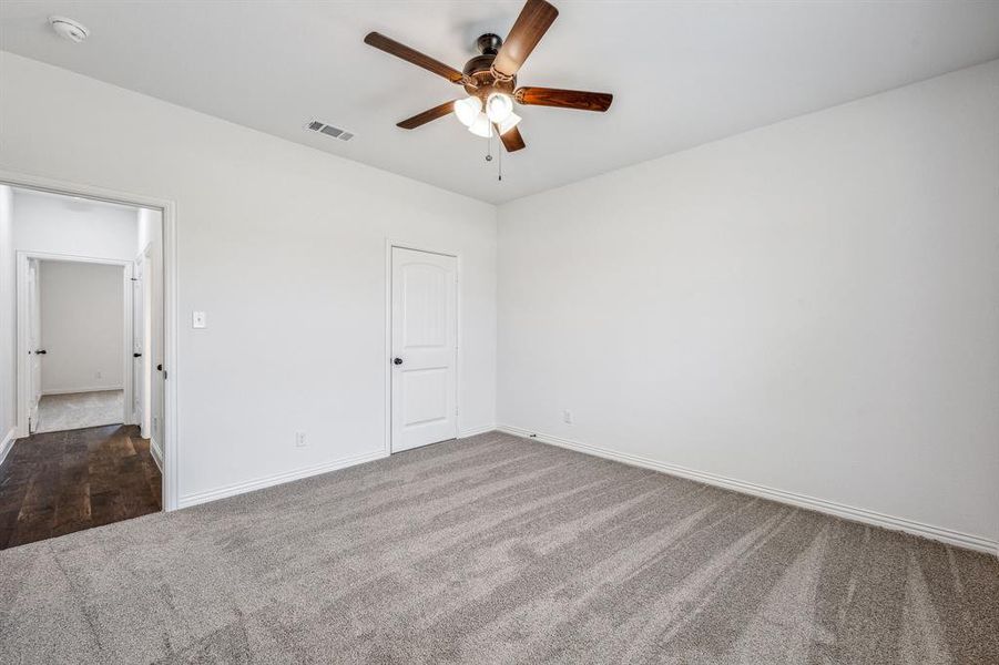 Spare room with carpet floors and ceiling fan