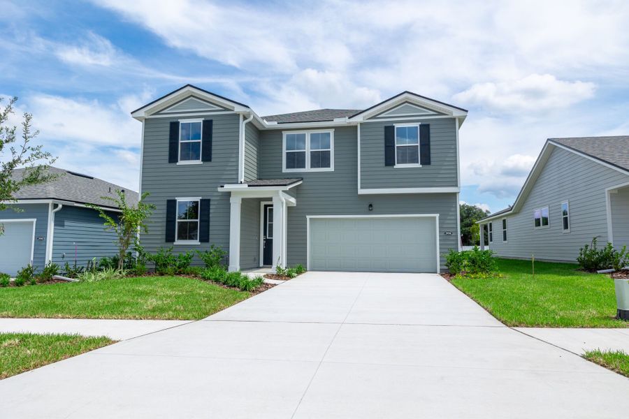 Front exterior of a new home in Sandridge Hills, Green Cove Springs, FL, highlighting curb appeal (Image 1).