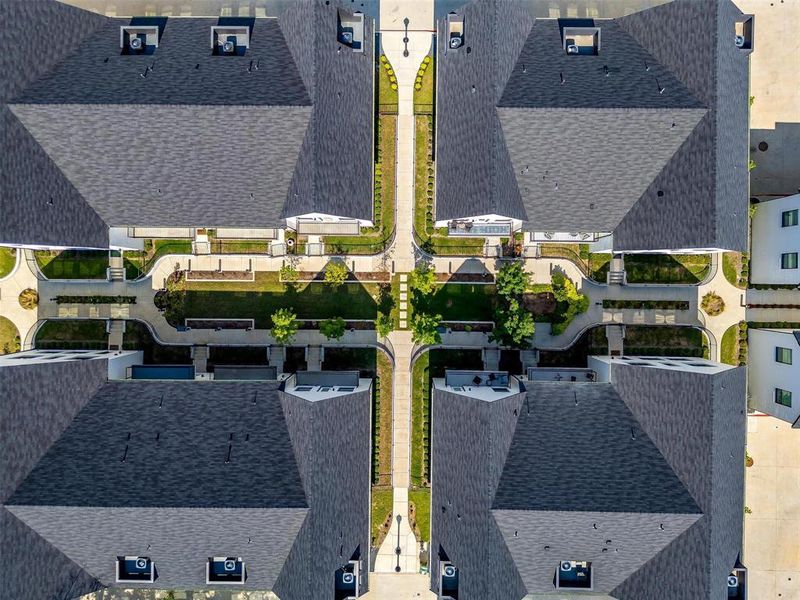 An aerial view of the luxury townhomes reveals a harmonious blend of modern architecture and lush landscaping.